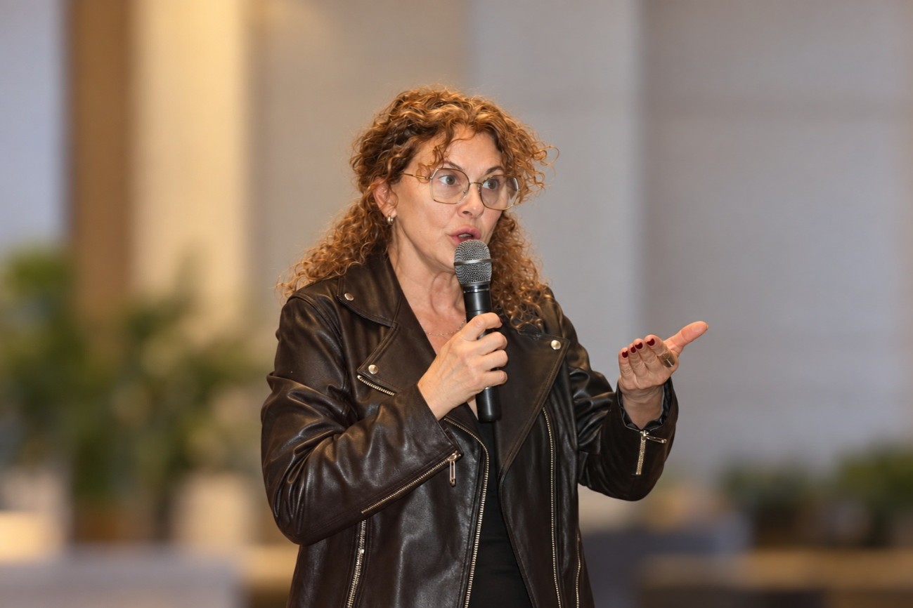 a woman wearing glasses and a denim jacket
